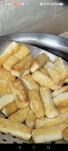 Lift the fried tofu out with a slotted spoon and set it in a strainer or on paper towels to drain off the excess oil.