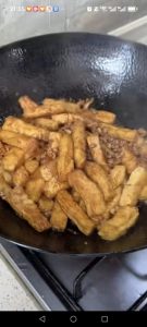 Toss everything together gently with your spatula so the tofu picks up the sauce without breaking apart.
