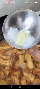 Pour in the hot water, then add the sugar, chicken bouillon, and a small pinch of salt, and simmer over medium heat for a few minutes so the tofu absorbs the sauce.