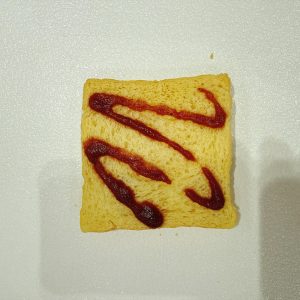 Squeeze ketchup evenly over the toast.
