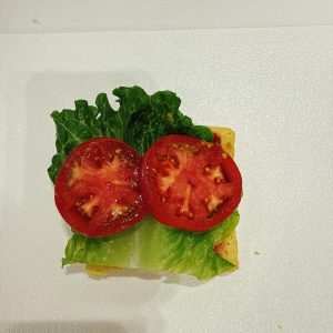 Lay tomato slices over the lettuce.