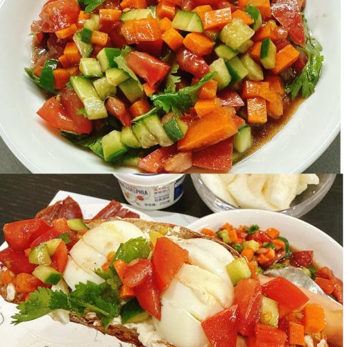 Chopped vegetable salad with diced tomato, carrot, cucumber, and cilantro in a clear glass bowl