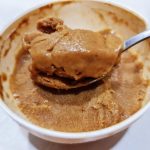 Coffee banana ice cream scooped into a bowl, silky and pale brown with a coffee swirl