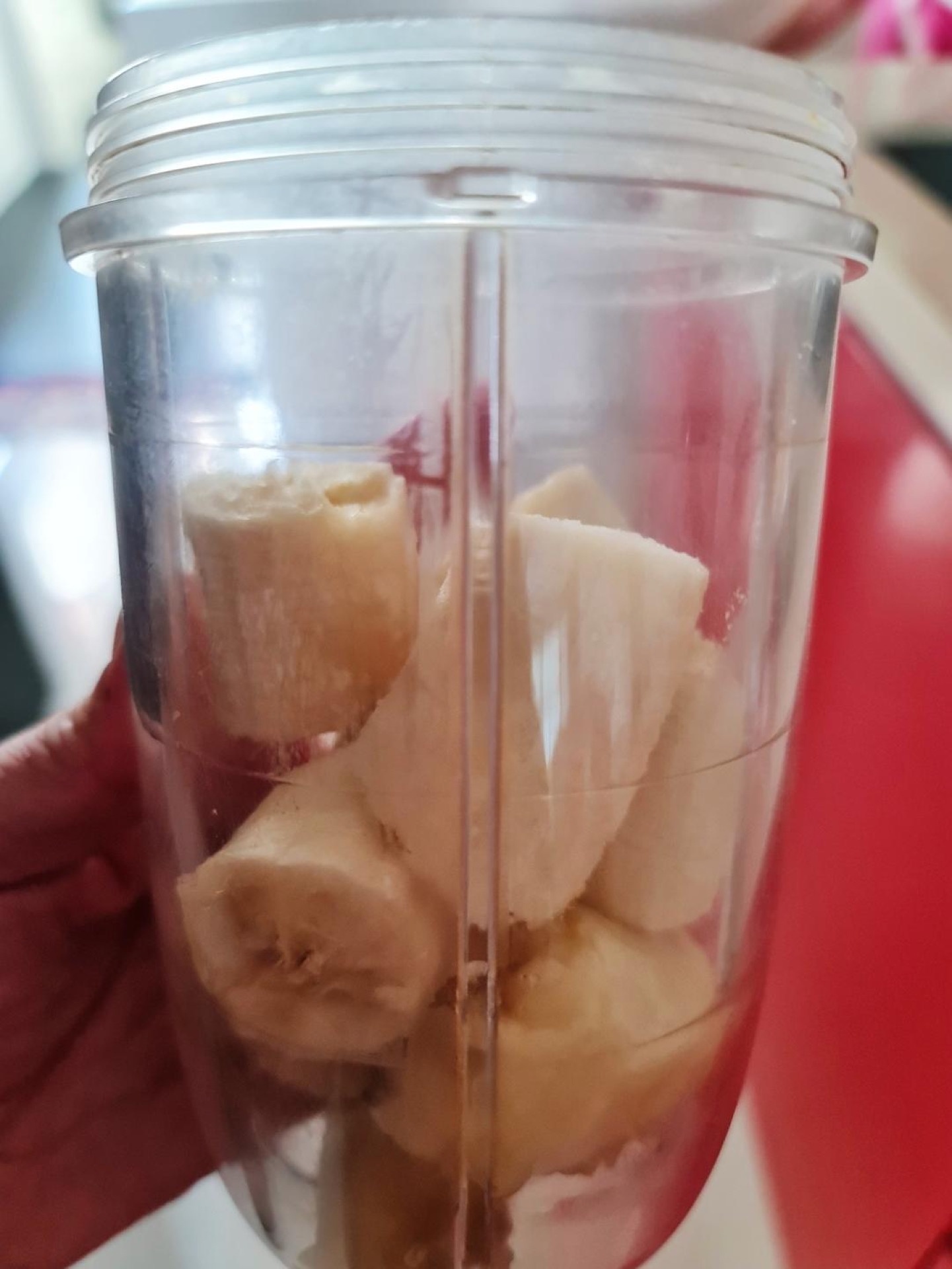 Peel the fully ripe bananas, break them into small chunks, and put them into the blender.