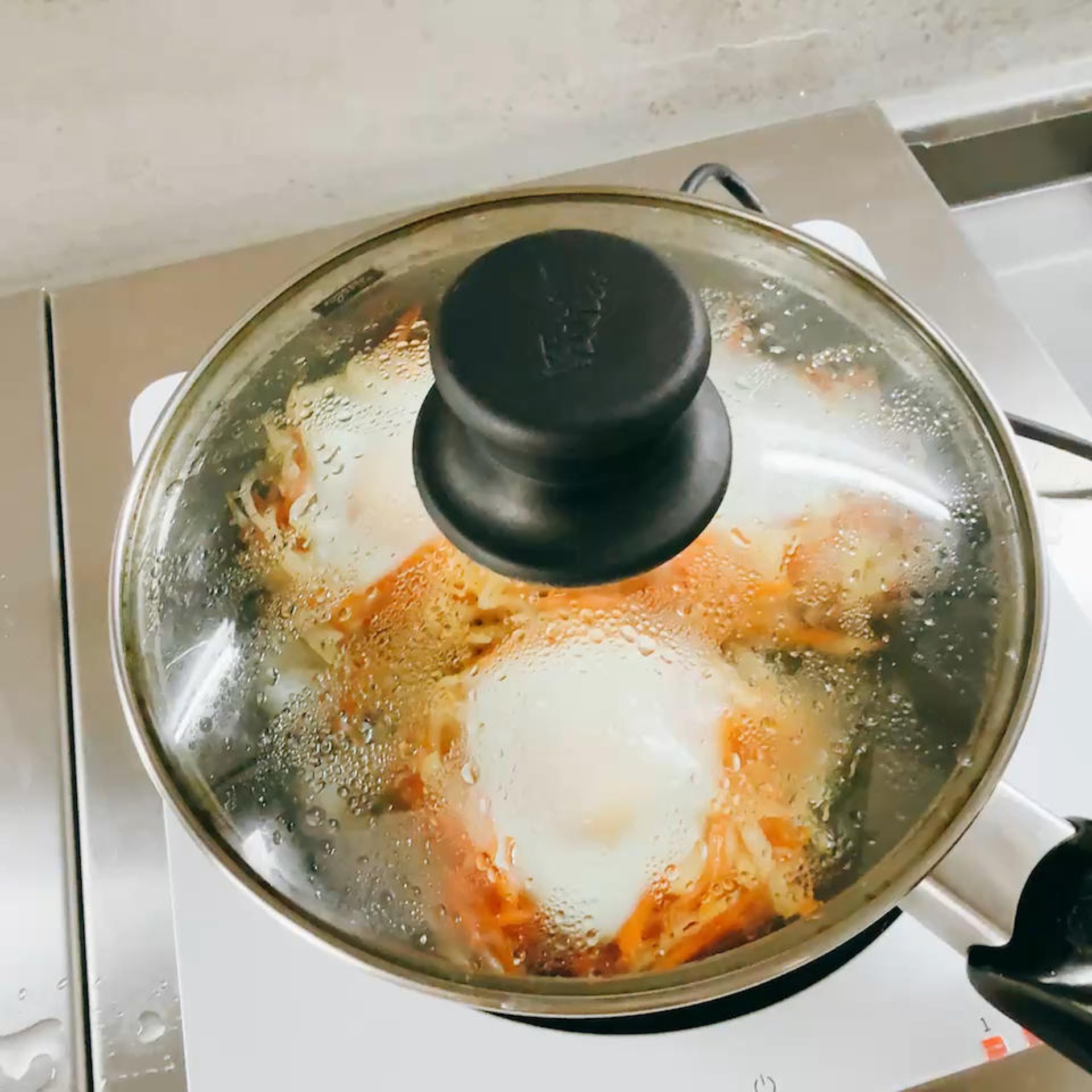 Cover the wok with a lid and let the pancakes steam for a moment until the eggs have set, keeping the heat low the whole time.