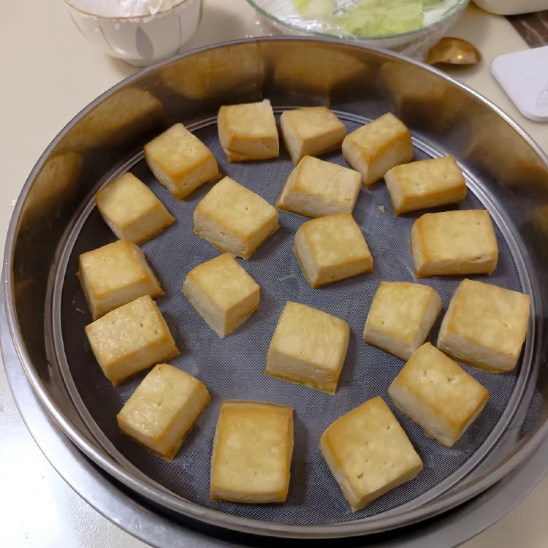 Dry the tofu in a 60°C oven for 5 hours; the photo above shows 65°C for 2.5 hours followed by 60°C for 2.5 hours, which left the tofu too dry and formed a skin.