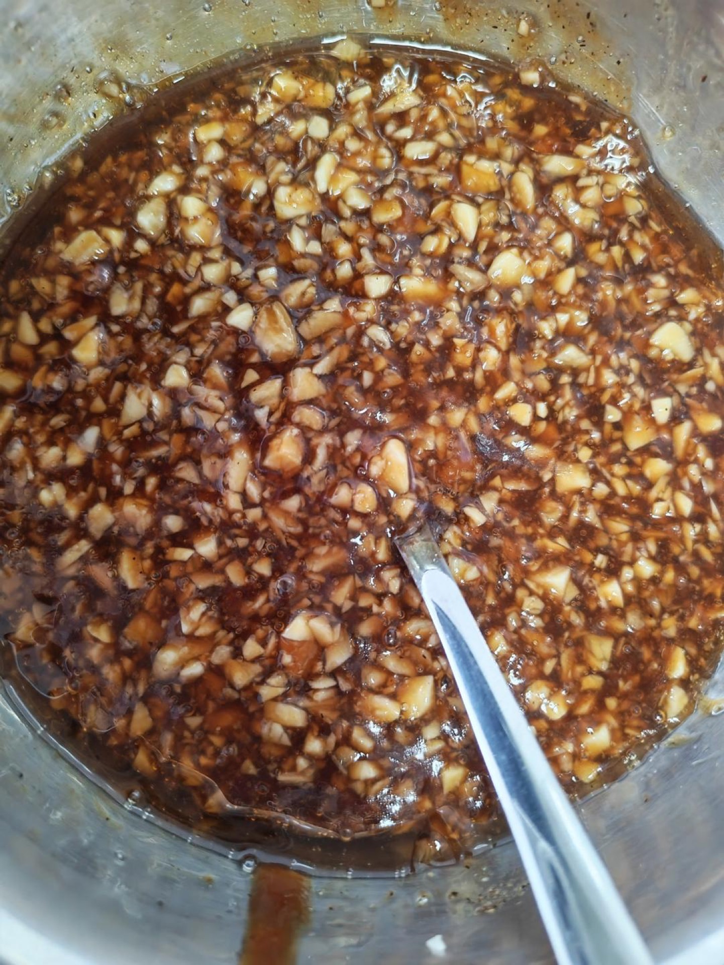 Pound the garlic until broken and fragrant, then stir in the oyster sauce, white vinegar, sugar, aged black vinegar, chicken bouillon, MSG, black pepper, seasoned soy sauce, and se