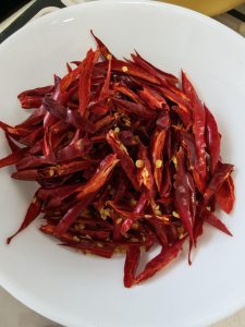 Snip the dried red chilies into fine thin shreds.