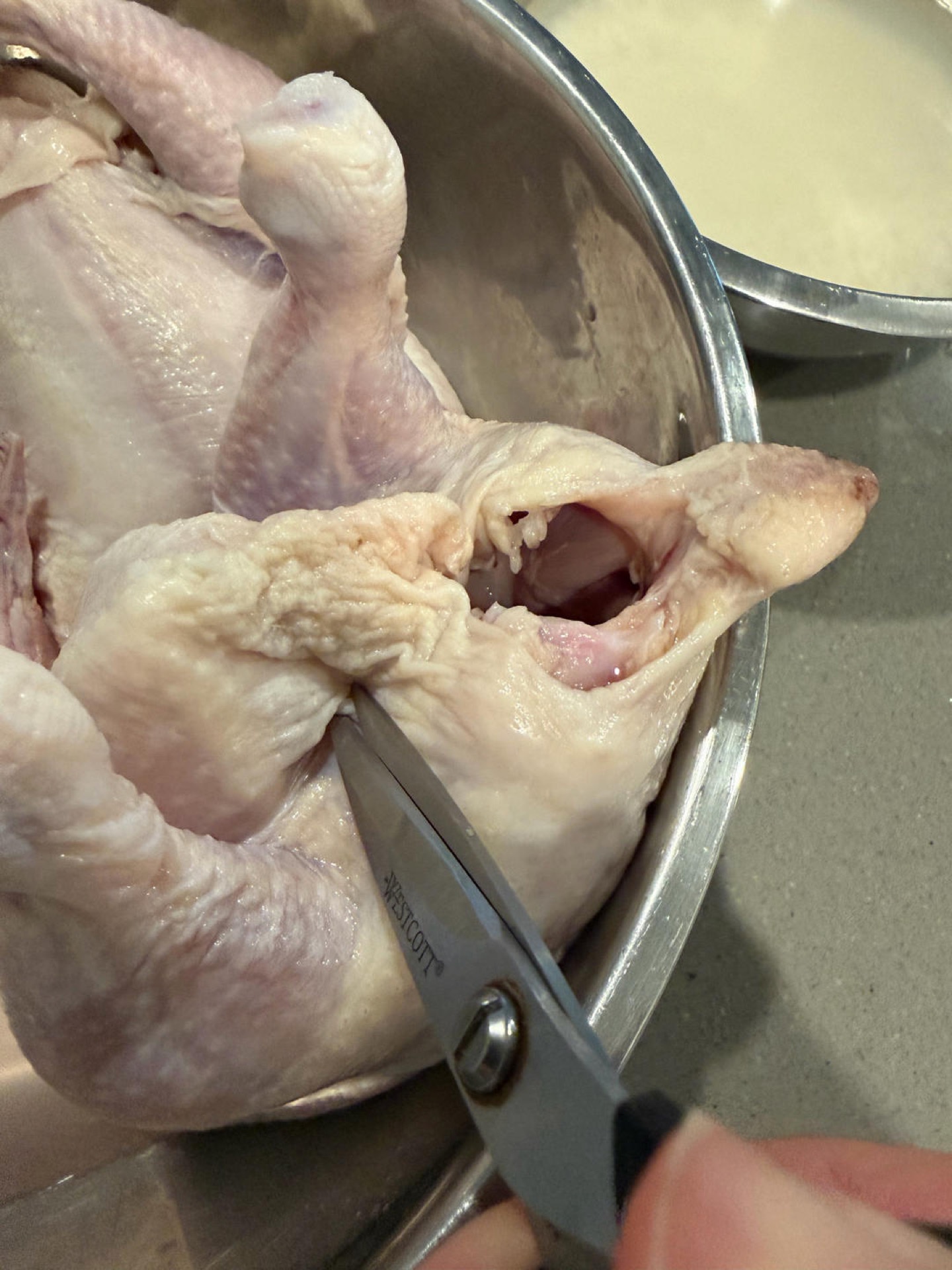 Use kitchen scissors to poke one small hole through the skin on each side near the tail.