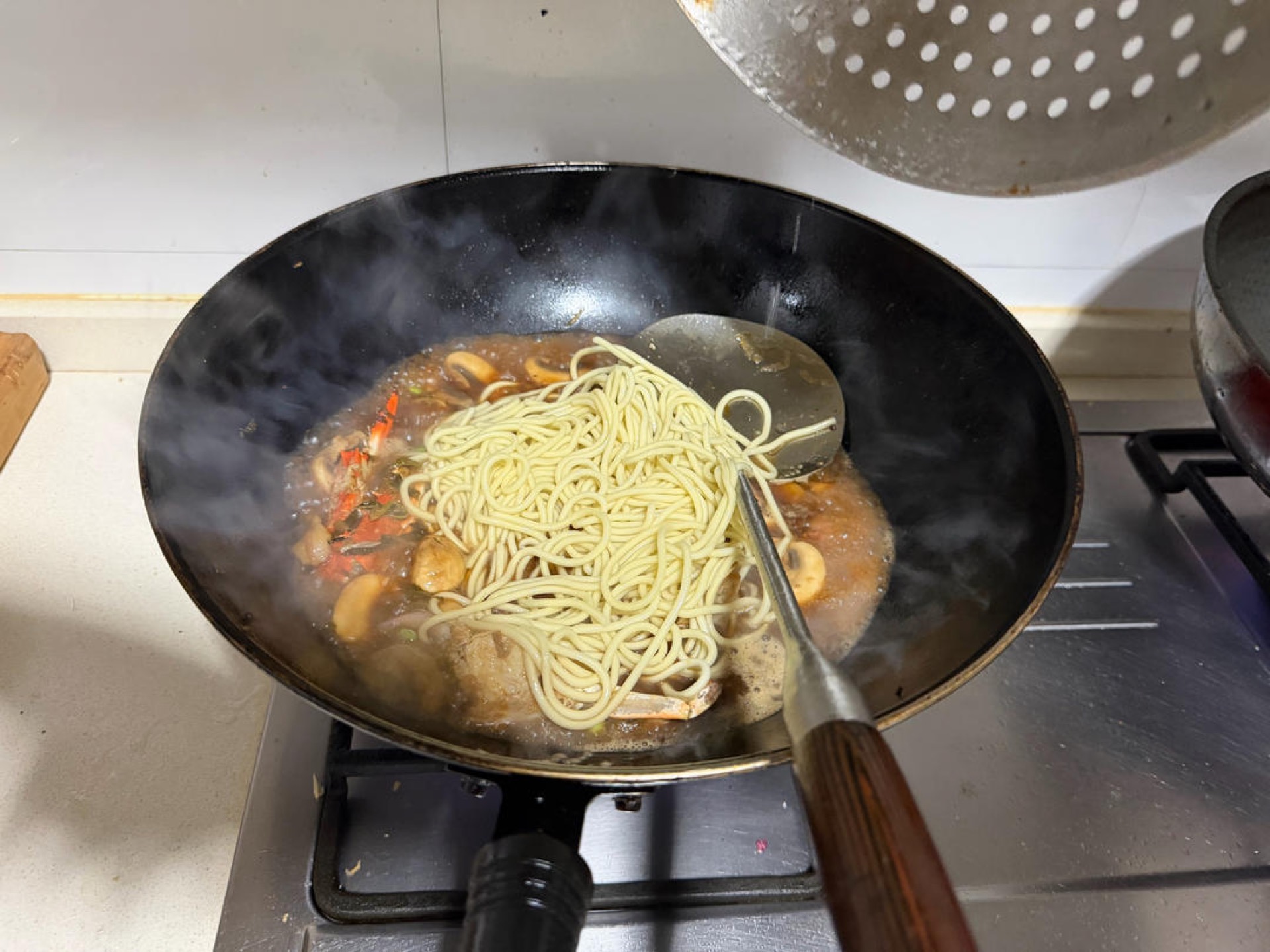 Add the noodles to the wok and cook over the highest heat for 90 seconds — that is enough.