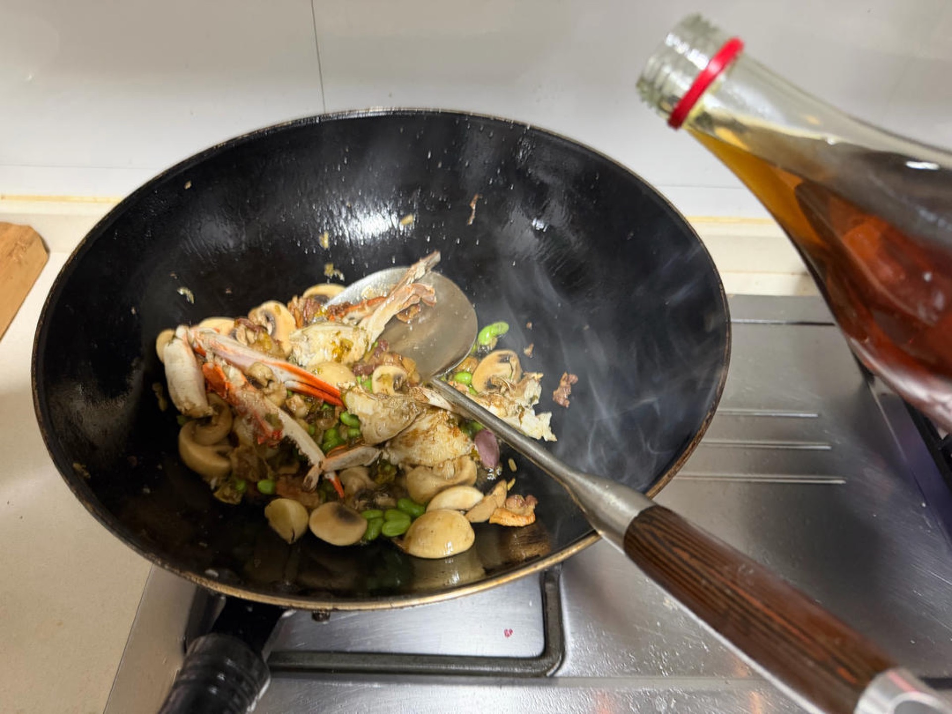 Pour the Shaoxing wine in a circle around the rim of the wok.