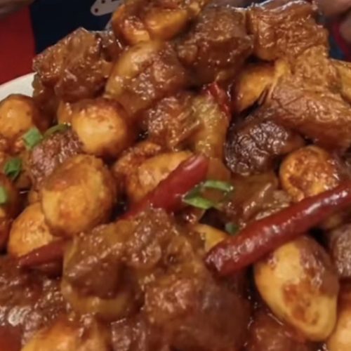 Home-style braised beef with tofu skin knots and quail eggs in a dark savory sauce