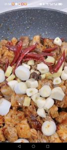 Add the scallions, ginger, garlic, dried chilis, and star anise and stir-fry until evenly combined.