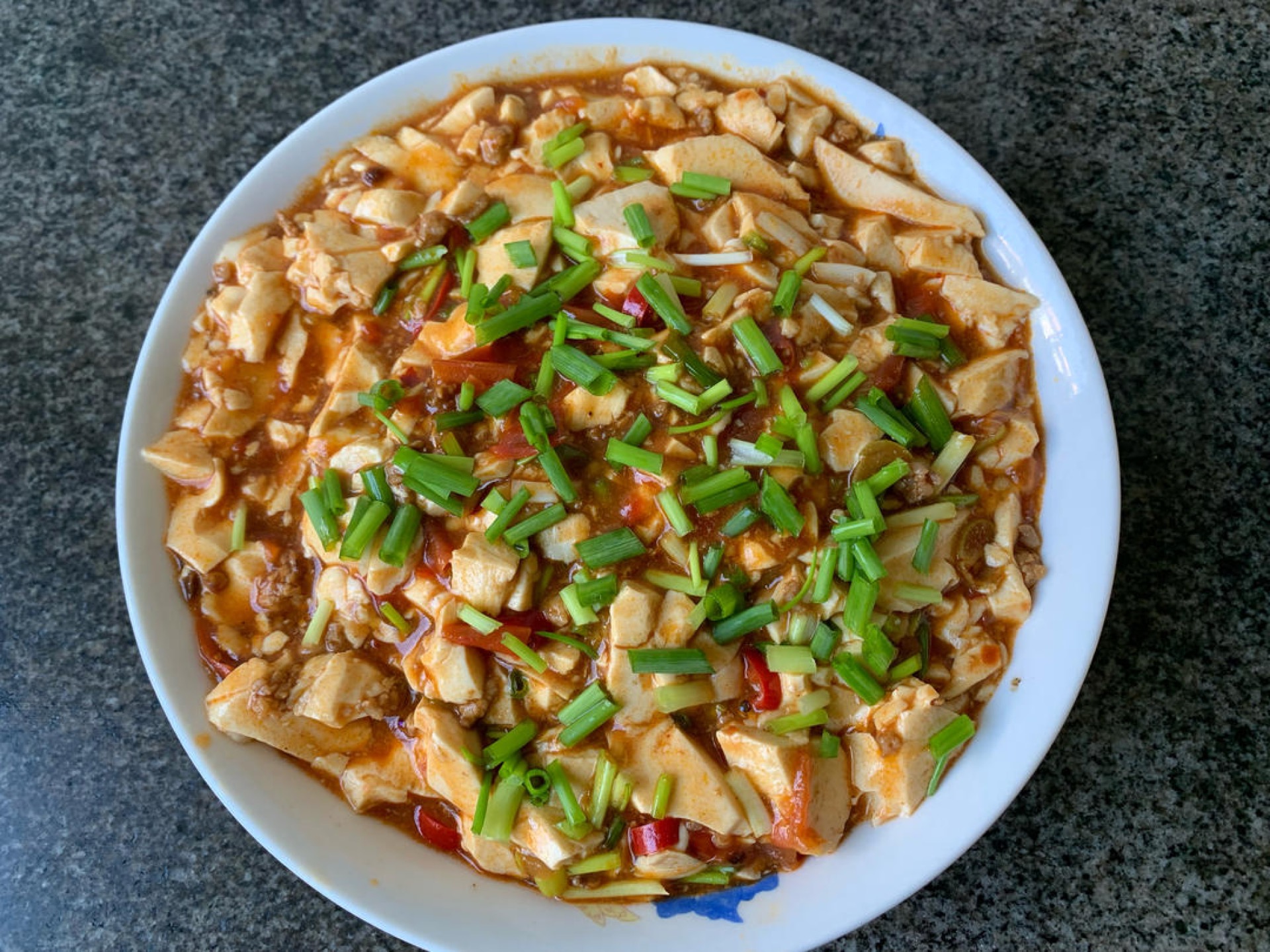 Scatter the sliced scallions over the top and serve immediately.