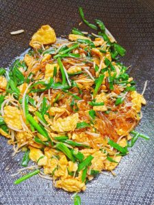 Add the salt, light soy sauce, oyster sauce, and chicken bouillon, then stir-fry over high heat, tossing constantly to combine.