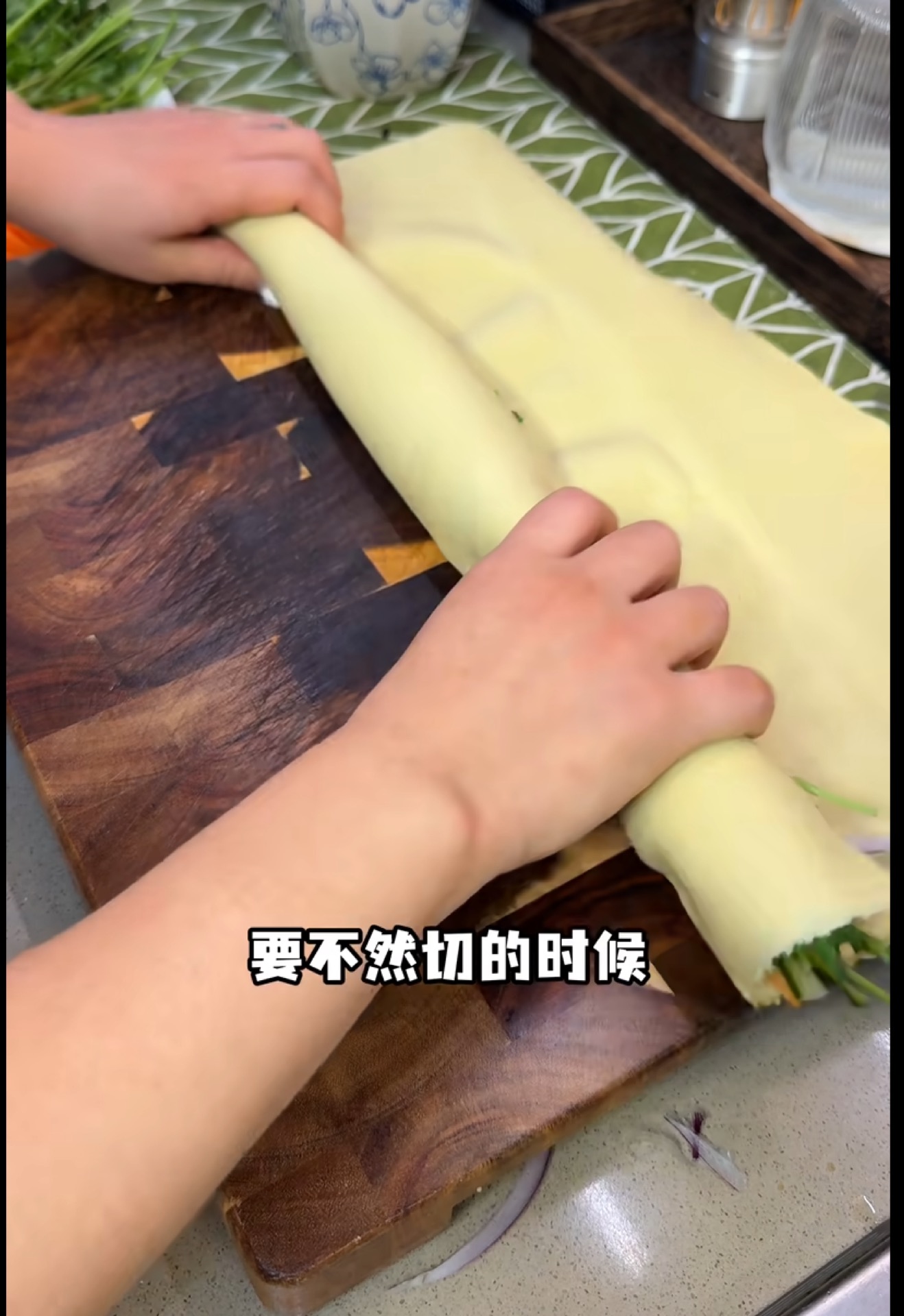 Roll the tofu skin up around the filling, pressing firmly as you go so the bundle stays compact and holds together.