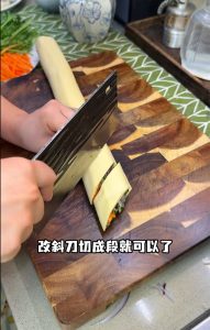 Cut the roll on a sharp diagonal into segments, then arrange them in a ring around the outer edge of a serving plate.