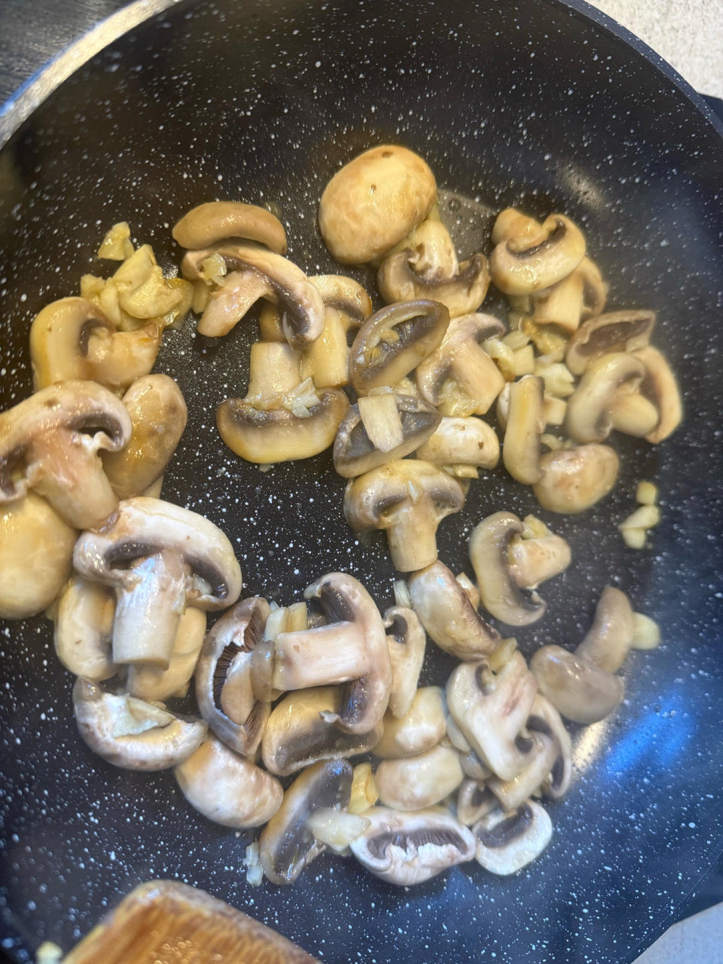 Turn the heat to medium and add the mushrooms, stir-frying for 3 minutes until they soften and begin to brown.