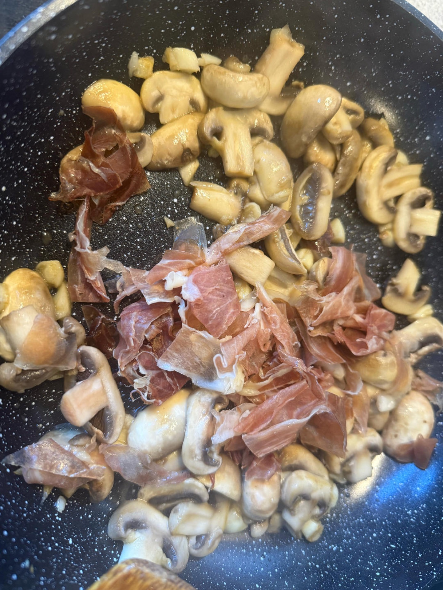 Scatter in the Parma ham and stir-fry for 1 minute so it warms through and flavors the mushrooms.