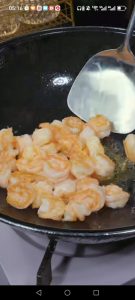 Add another tablespoon of oil to the wok, sear the shrimp 1 to 2 minutes per side until they curl and turn opaque, then remove them and set aside with the chicken.