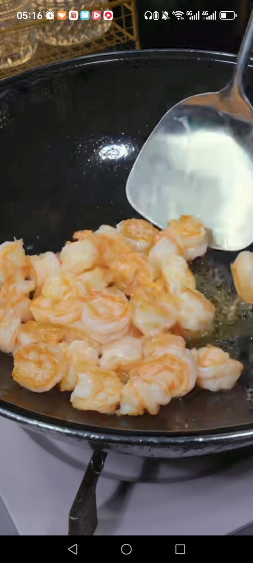 Add another tablespoon of oil to the wok, sear the shrimp 1 to 2 minutes per side until they curl and turn opaque, then remove them and set aside with the chicken.