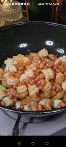 Slide the chicken, shrimp, and roasted peanuts back into the wok and toss everything together over high heat.