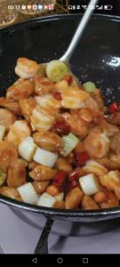 Pour in the sauce, stir fry 30 to 45 seconds until it thickens into a glossy coat, then finish with 1 tablespoon chili oil, toss once more, and turn off the heat.