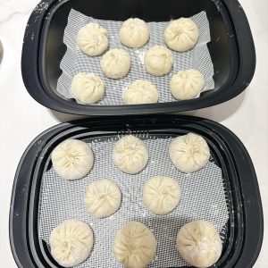 Place them on a steaming tray lined with baking paper and into the steamer.