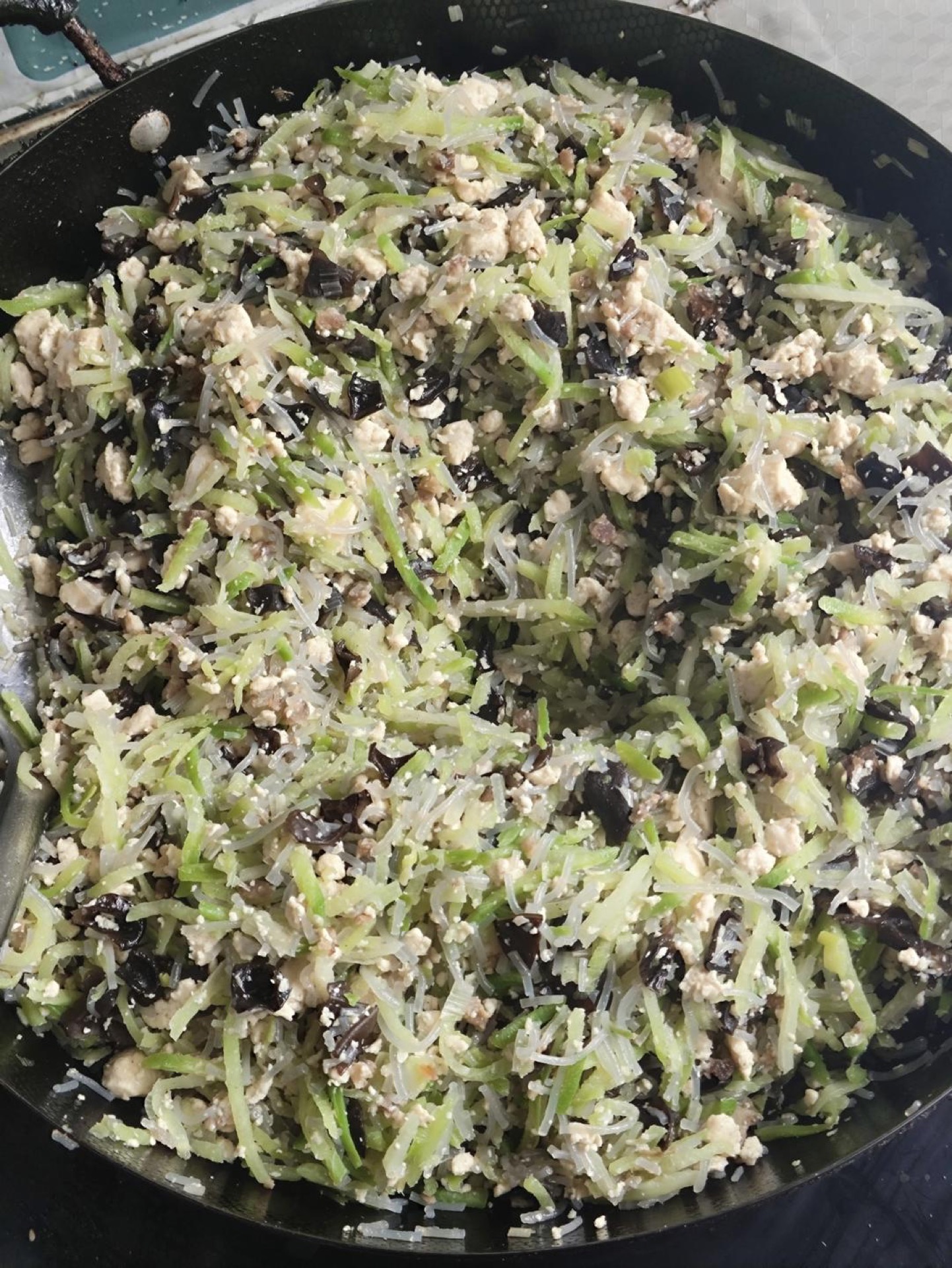 Add the vermicelli and shredded radish. Season with salt, five-spice powder, and soy sauce. Stir-fry until well combined. Taste and adjust seasoning — it should be slightly saltier