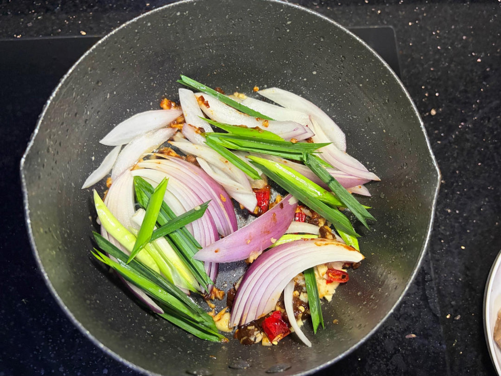 Add the onion and garlic and stir-fry for a few seconds.