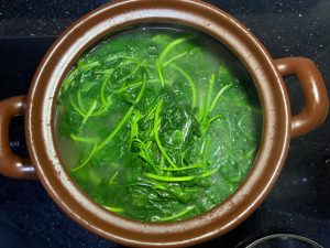 Add amaranth greens and simmer about 1 minute before serving — greens blanched in rib broth make both the vegetable and the soup sweet and fresh.