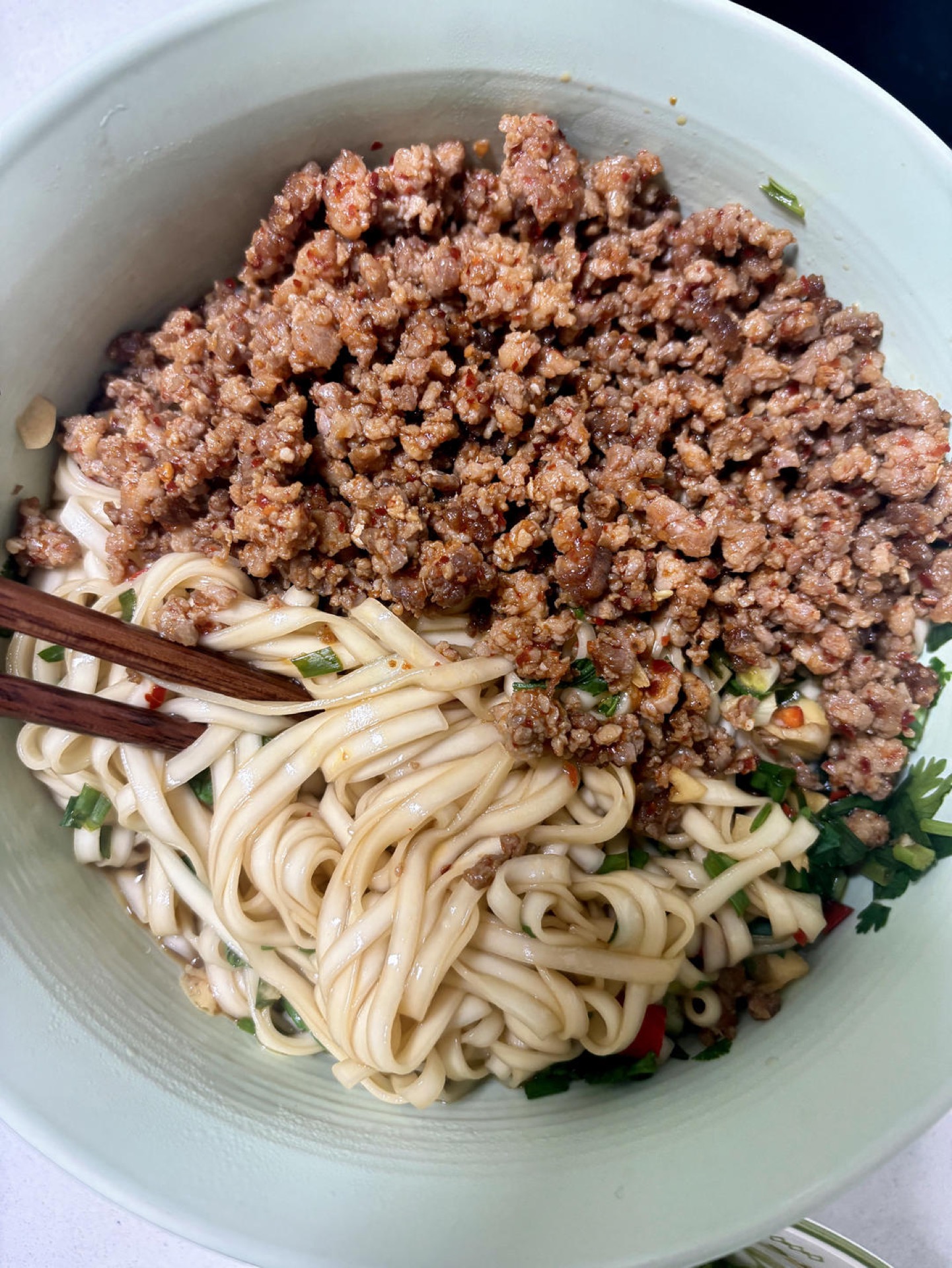 Lift the noodles out and lay them over the base, with plenty of fried sauce.