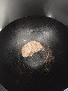 Add the peppercorn salt to a cold cast iron wok and heat until it smokes and smells fragrant, about one minute, then turn off the heat and keep tossing the peppercorn salt in the r