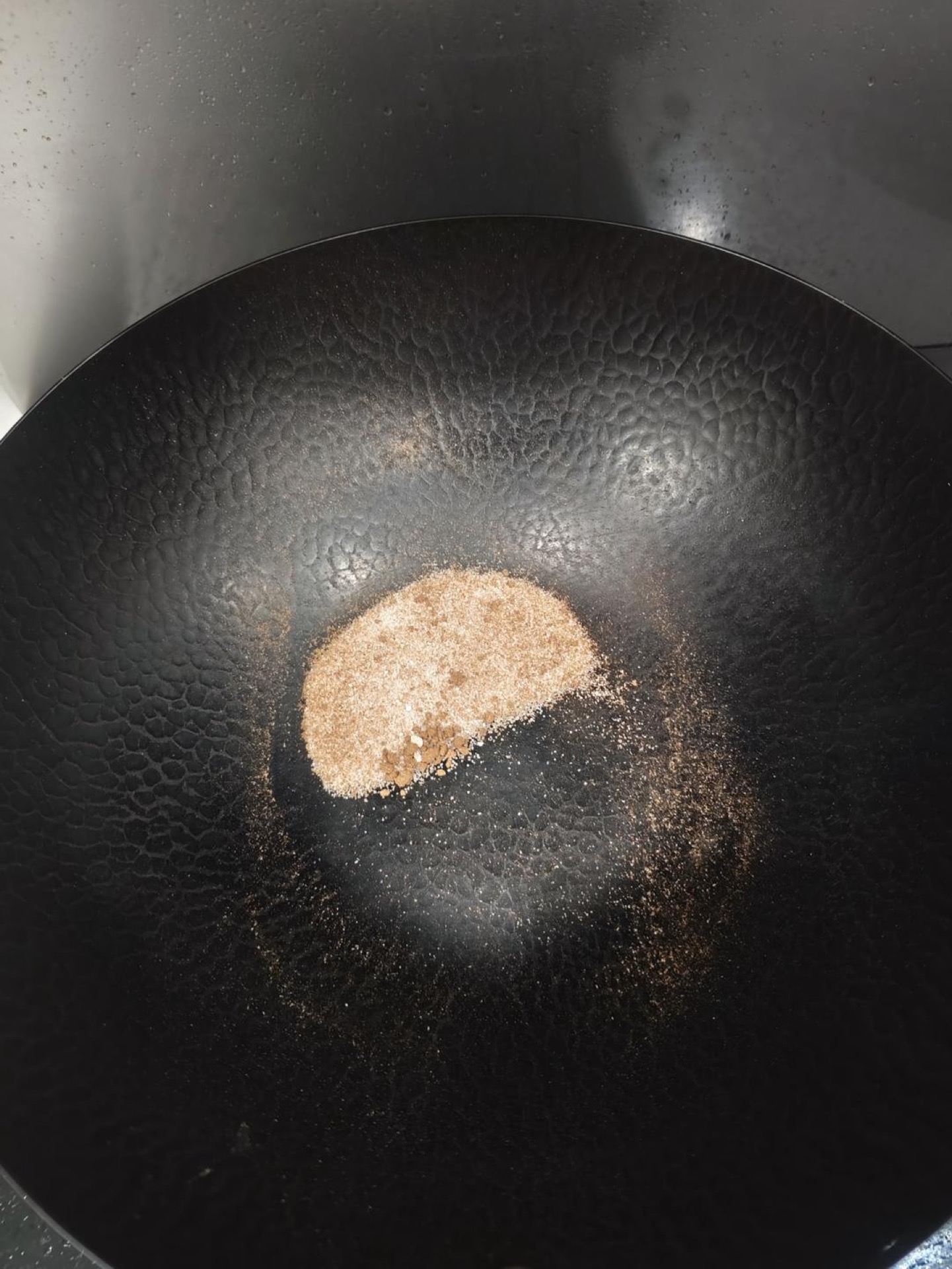 Add the peppercorn salt to a cold cast iron wok and heat until it smokes and smells fragrant, about one minute, then turn off the heat and keep tossing the peppercorn salt in the r