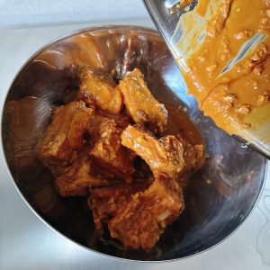 Pour the coated ribs out into a bowl.