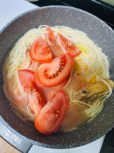 Add the tomato wedges, season with salt, and simmer until the tomato softens.