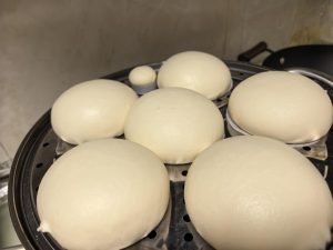 Once they have proofed to 1–1.5 times their size, you can turn on the heat and steam them! Steam for 15 minutes, then let them sit covered for 3 minutes. Remember to take the dough