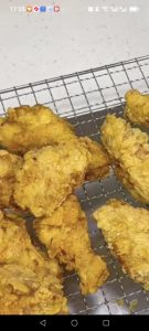 The wings are now golden and crisp and ready for the cheese powder.