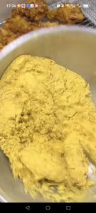 Pour the snow cheese powder into a bowl, add the fried wings, and shake the bowl back and forth so every wing is coated in the snowy cheese powder.