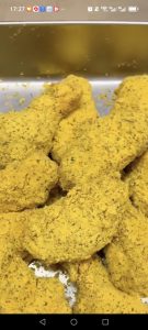The finished snow cheese chicken wings are coated in a snowy layer of cheese powder and ready to serve.
