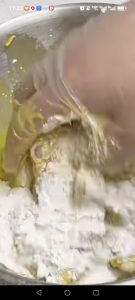 Pour off the milk from the marinated wings and pick out the solids, then add some of the coating mix and one egg to the wings.