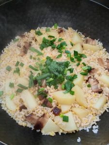 Let the bottom of the wok turn slightly crisp and browned, which is the best part, then scatter chopped scallions over the top.