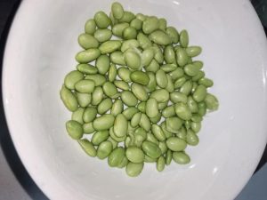 Rinse the edamame clean and spread it in an even layer across the bottom of a deep heatproof bowl.