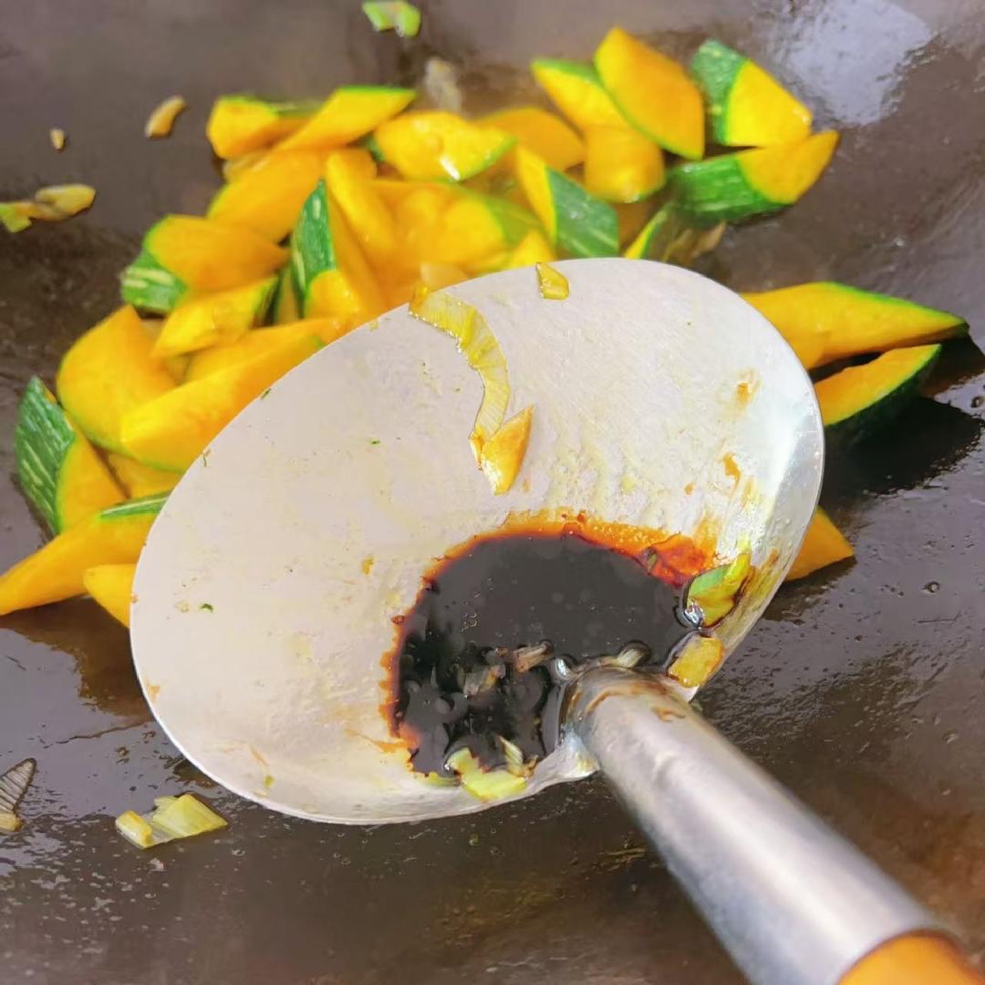 Add a small spoon of light soy sauce and toss until the pumpkin takes on color.