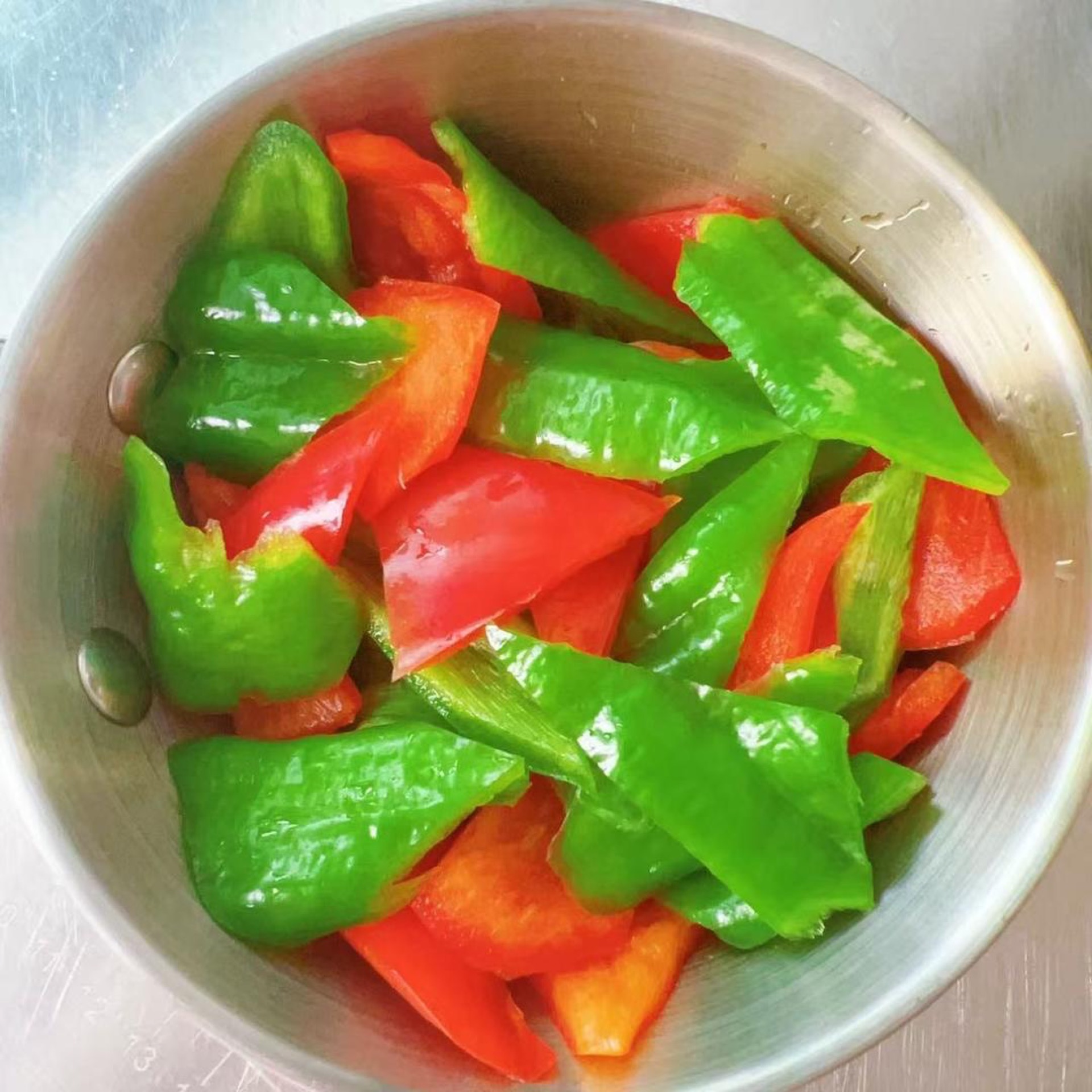 Seed and stem the green and red peppers, then cut them into small chunks the same size as the pumpkin.
