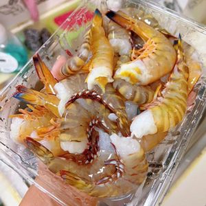 Twist off the heads of the red-claw, blue-tail, and tiger shrimp with a slow pull so the head and the digestive tract come away together.