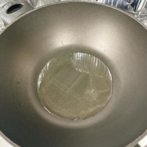 Heat oil in the wok.