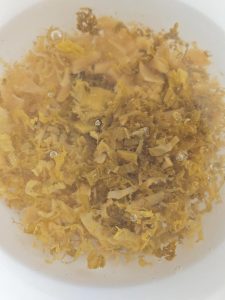 Rinse the shredded pickled cabbage in clean water two or three times, then squeeze it dry; this washes away the stale, overly salty edge and leaves only the clean fermented tang.