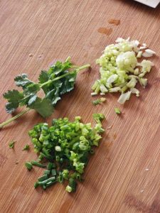 Split the scallion into white and green parts, and set the cilantro aside for garnish.