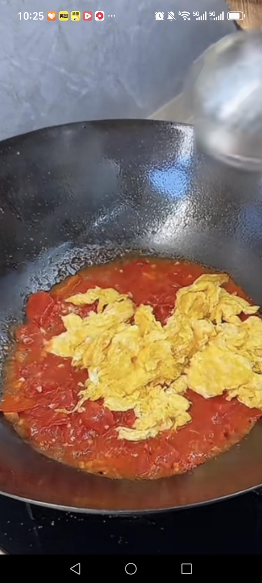 Add the tomato wedges, press them down with your spatula until they break apart into a jammy pulp, stir in the light soy sauce, then return the fried eggs to the wok.